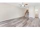 Living room with grey flooring, ceiling fan, staircase, and a powder room for added convenience at 2957 Smith Ridge Trce, Peachtree Corners, GA 30071