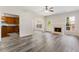 Open-concept living room with hardwood floors, fireplace, and a view of the kitchen at 2957 Smith Ridge Trce, Peachtree Corners, GA 30071