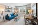 Comfortable home office featuring a blue sofa, stylish desk, and tranquil setting for productivity at 7169 Brushwood Bend - Lot 37, Lithonia, GA 30058