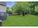 View of a spacious backyard with lush green grass and a wooden fence at 756 Joseph E Lowery Sw Blvd, Atlanta, GA 30310