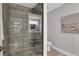 Modern bathroom with a glass-enclosed shower featuring stylish gray tiling and brushed nickel fixtures at 756 Joseph E Lowery Sw Blvd, Atlanta, GA 30310