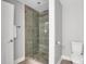 Sleek bathroom with a glass shower door, light gray walls, and a toilet at 756 Joseph E Lowery Sw Blvd, Atlanta, GA 30310