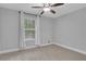 Light-filled bedroom with plush carpeting, neutral walls, a ceiling fan, and a window with sheer curtains at 756 Joseph E Lowery Sw Blvd, Atlanta, GA 30310