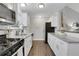 Well-lit kitchen with granite countertops, stainless appliances, wood floors, and white cabinets at 756 Joseph E Lowery Sw Blvd, Atlanta, GA 30310
