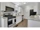 Modern kitchen with white cabinets, granite countertops, and stainless steel appliances at 756 Joseph E Lowery Sw Blvd, Atlanta, GA 30310