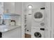 Convenient laundry area with stacked washer and dryer, next to the kitchen with white cabinets at 756 Joseph E Lowery Sw Blvd, Atlanta, GA 30310