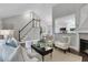 Cozy living room with a staircase and open view to the adjacent kitchen and dining area at 756 Joseph E Lowery Sw Blvd, Atlanta, GA 30310