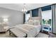 Cozy bedroom with accent wall, stylish lighting, and window views at 756 Joseph E Lowery Sw Blvd, Atlanta, GA 30310