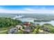 Aerial view of lakefront estate home nestled in lush greenery overlooking the lake and surrounding community at 89 Somerset Ln, Cartersville, GA 30121