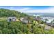 Aerial view of lakefront estate home nestled among lush greenery overlooking the lake and surrounding area at 89 Somerset Ln, Cartersville, GA 30121