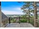 Balcony with iron railings, a tile floor, and a scenic view of the trees and lake at 89 Somerset Ln, Cartersville, GA 30121