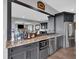 Attractive bar with dark wood cabinets, stainless steel appliances and plenty of liquor storage at 89 Somerset Ln, Cartersville, GA 30121