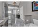 This spacious bathroom includes a glass shower, marble, double sinks and chandelier at 89 Somerset Ln, Cartersville, GA 30121