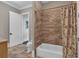 Bathroom with shower and tub combination, white fixtures and tile floor at 89 Somerset Ln, Cartersville, GA 30121