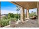 Relaxing covered patio with stone columns, comfortable seating, and stunning views of the surrounding mountains at 89 Somerset Ln, Cartersville, GA 30121