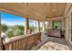 Covered patio features a hot tub, comfortable seating, stone columns, and beautiful views of the surrounding landscape at 89 Somerset Ln, Cartersville, GA 30121