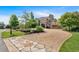 Stately two-story home featuring brick, siding, arched entryway, circular driveway, and lush landscaping at 89 Somerset Ln, Cartersville, GA 30121