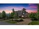 Charming two-story home with stone and siding, lush landscaping, and a circular driveway at twilight at 89 Somerset Ln, Cartersville, GA 30121