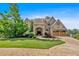 Inviting home exterior featuring manicured lawn, mature trees, and an arched front entry at 89 Somerset Ln, Cartersville, GA 30121