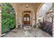 Inviting front porch with arched brick entryway, double doors, and decorative stone flooring at 89 Somerset Ln, Cartersville, GA 30121