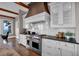 Well-appointed kitchen boasting stainless steel appliances, custom cabinets, tile backsplash, and hardwood floors at 89 Somerset Ln, Cartersville, GA 30121