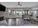 Spacious living room boasts a stone fireplace, hardwood floors, and large windows with beautiful outdoor views at 89 Somerset Ln, Cartersville, GA 30121