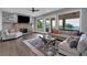 Bright living room features hardwood floors, a stone fireplace, and large windows that fill the space with natural light at 89 Somerset Ln, Cartersville, GA 30121