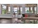 Inviting living room features neutral decor, hardwood floors, and sliding glass doors to a covered patio with scenic views at 89 Somerset Ln, Cartersville, GA 30121