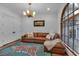 A cozy living room features wood flooring, a stylish rug, a comfortable sofa, and arched windows at 89 Somerset Ln, Cartersville, GA 30121
