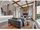 Spacious living room featuring a stone fireplace, hardwood floors, beamed ceiling, and open staircase at 89 Somerset Ln, Cartersville, GA 30121