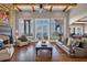 Bright living room with high ceilings, a stone fireplace, and expansive windows showcasing mountain views at 89 Somerset Ln, Cartersville, GA 30121