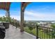 This covered patio has an incredible view of the lake and surrounding landscape with outdoor furniture and a grill at 89 Somerset Ln, Cartersville, GA 30121