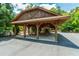 Community pavilion area with picnic tables, a fireplace, and a convenient parking area at 89 Somerset Ln, Cartersville, GA 30121