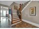 Inviting foyer staircase with hardwood steps and rod iron balusters, seamlessly blending elegance with architectural design at 89 Somerset Ln, Cartersville, GA 30121