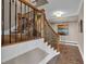 Elegant staircase with wooden treads, dark iron railings, and natural light at 89 Somerset Ln, Cartersville, GA 30121