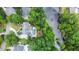 Aerial view of a home with a pool and lush landscaping backing onto a serene lake at 965 Tiverton Ln, Alpharetta, GA 30022