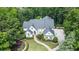 An aerial view showcasing a luxurious house surrounded by lush greenery and well-maintained landscaping at 965 Tiverton Ln, Alpharetta, GA 30022