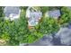 Aerial view of estate with pool, overlooking lake, surrounded by mature trees at 965 Tiverton Ln, Alpharetta, GA 30022