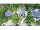 Aerial view of luxury home with meticulous landscaping, inground pool, and lake access at 965 Tiverton Ln, Alpharetta, GA 30022