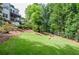 Expansive backyard with lush lawn, mature trees, and elegant landscaping, perfect for outdoor activities at 965 Tiverton Ln, Alpharetta, GA 30022