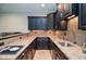 Wet bar featuring custom black cabinets, light granite countertops and tiled floors at 965 Tiverton Ln, Alpharetta, GA 30022