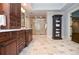 Large bathroom featuring a large shower, tiled floors, bright lighting, and wood cabinets with large vanity space at 965 Tiverton Ln, Alpharetta, GA 30022