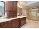Elegant bathroom featuring a custom wood vanity with drawers, cabinets, and a luxurious glass enclosed shower at 965 Tiverton Ln, Alpharetta, GA 30022