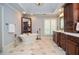 Large bathroom features a soaking tub, tiled floors, bright lighting, and wood cabinets with large vanity space at 965 Tiverton Ln, Alpharetta, GA 30022