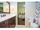 Bathroom with wooden vanity, granite countertops, with view of the adjacent bedroom at 965 Tiverton Ln, Alpharetta, GA 30022