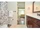 Bathroom with dark wood vanity, white countertops, and a floral patterned shower curtain at 965 Tiverton Ln, Alpharetta, GA 30022