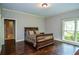 Serene bedroom with hardwood floors, a cozy bed, and natural light creating a peaceful ambiance at 965 Tiverton Ln, Alpharetta, GA 30022