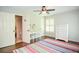 Well-lit bedroom featuring a colorful rug, shuttered windows, and an ensuite bathroom at 965 Tiverton Ln, Alpharetta, GA 30022