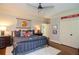 Bedroom with ceiling fan, sports memorabilia, and hardwood floors at 965 Tiverton Ln, Alpharetta, GA 30022