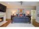 Bedroom with fireplace, hardwood floors, and Atlanta Hawks decor at 965 Tiverton Ln, Alpharetta, GA 30022